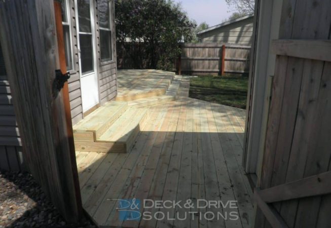 lower treated deck with steps up to house