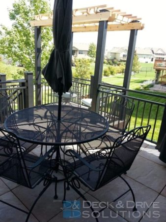 stone tile deck floor with wrought iron furniture