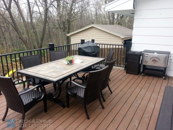 tile table and chairs on new composite decking in backyard