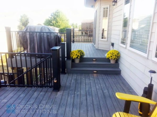 gray decking and yellow flowers