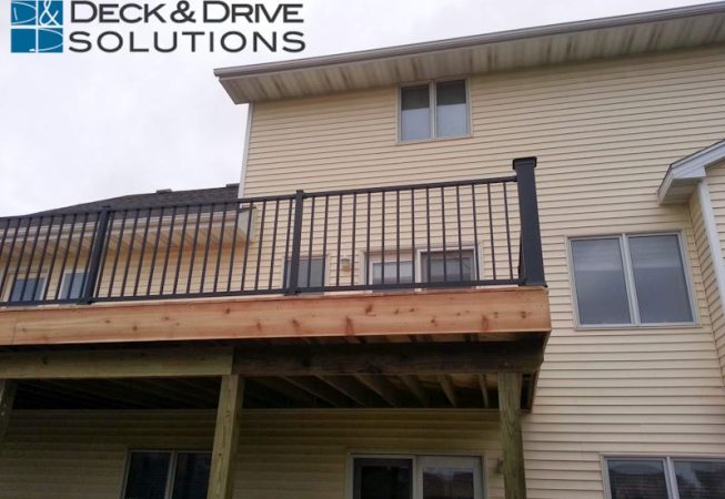 cedar deck and black railing from bottom