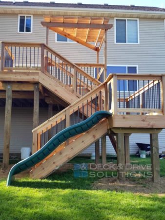 slide built next to stairs on cedar deck landing