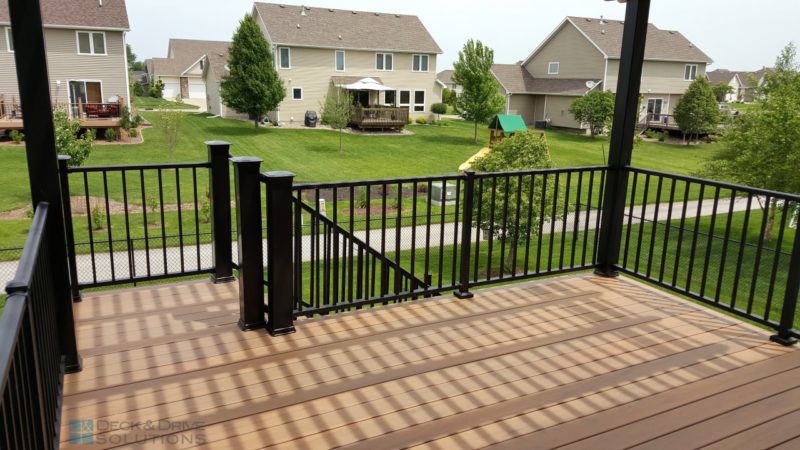 composite deck with large and small railing posts with a view of the backyard