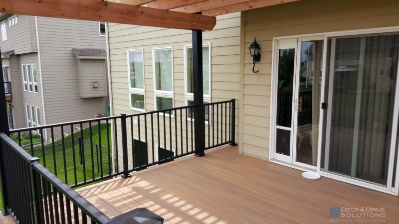 Composite deck with black posts and cedar pergola