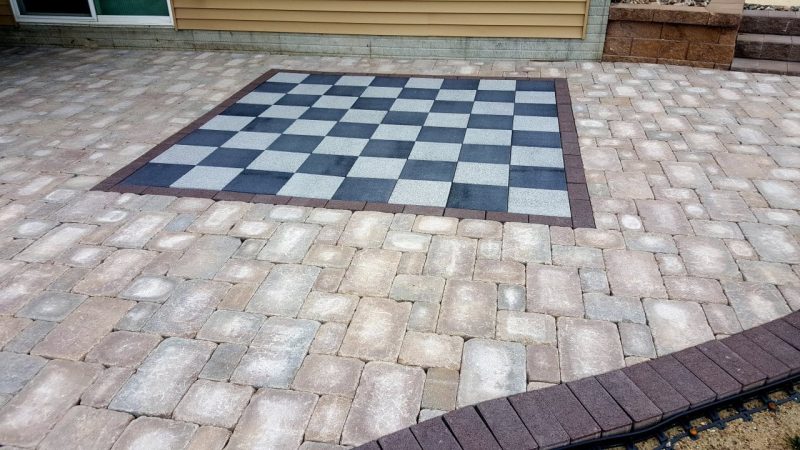 Chess board made by black and white patio pavers in a new patio