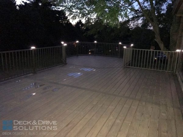evening deck picture of composite decking with Westbury post cap lights