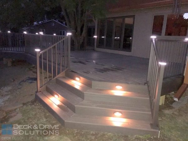 Night time with the deck lights on the angled stairs.  Railing post cap lights also