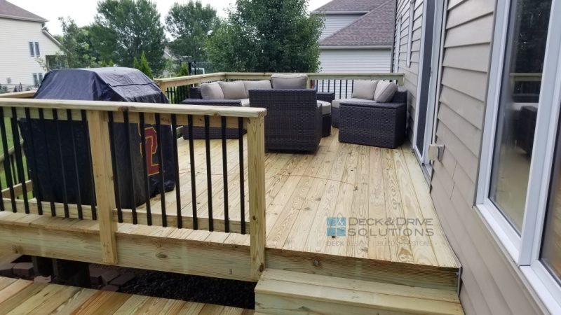 Outdoor deck furniture on treated deck