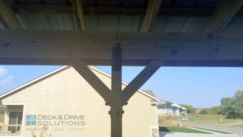 Treated Beam with Ozco Decorative Fasteners holding a metal roof
