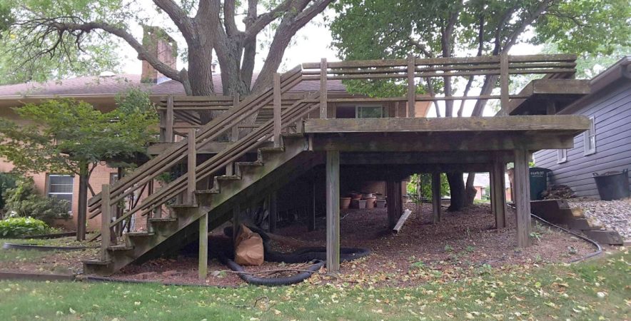 Old cedar deck in backyard of brick house
