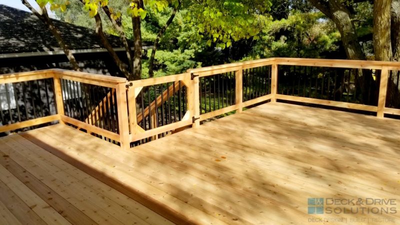 cedar decking with cedar railing gate, trees in the backyard