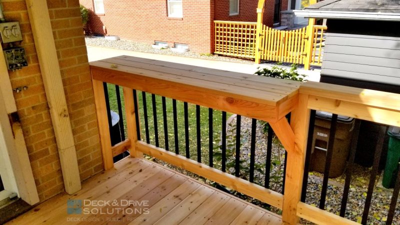 custom bar made from cedar on top of the railing