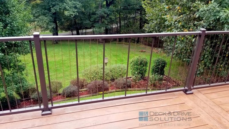 Westbury Verticable Railing in Bronze on brown deck with nice landscaped backyard