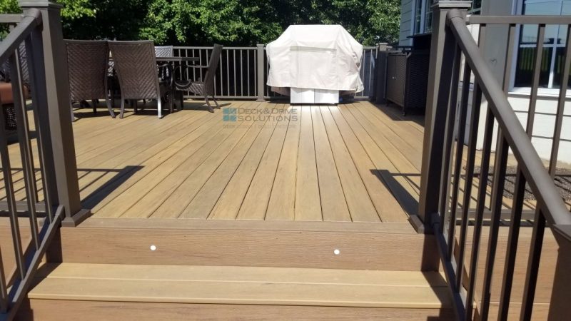 Composite deck, top of stairs with 2 dot lights, covered grill in end of deck