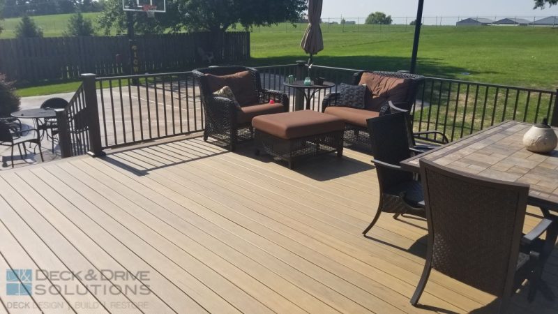 outdoor table and chairs on new Timbertech Legacy Tigerwood decking in backyard