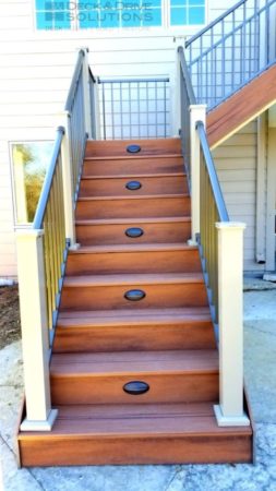 Trex Tiki Torch deck stairs with Timbertech stair riser lights and wesbury clay posts and bronze railing