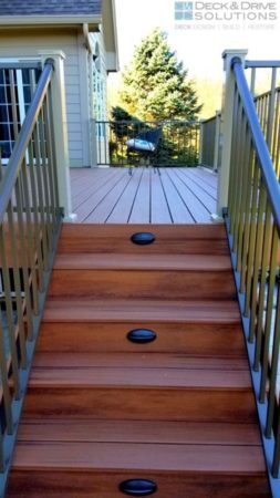 Trex Tiki Torch deck stairs with Timbertech stair riser lights and wesbury clay posts and bronze railing