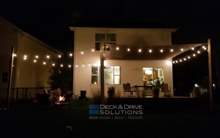 Overhead lighting with Shade Sail on a deck in the night