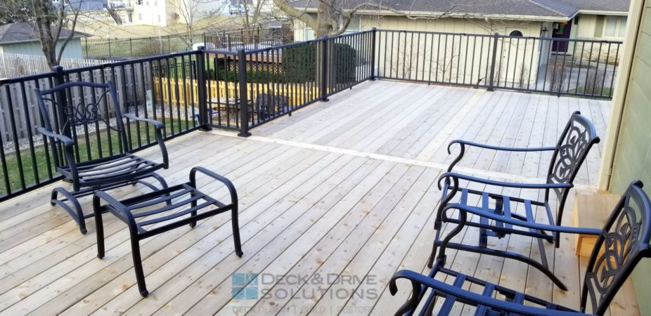 Cedar Decking with metal railing and some outdoor chairs