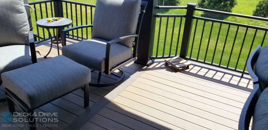 picture frame board in mocha surrounded by a pecan decking.  Chair with white cushions