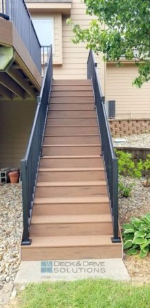 composite deck stairs in brown oak and black metal railing