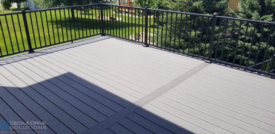 Trex Deck floor in Clam Shell with picture frame board in center and black metal railing