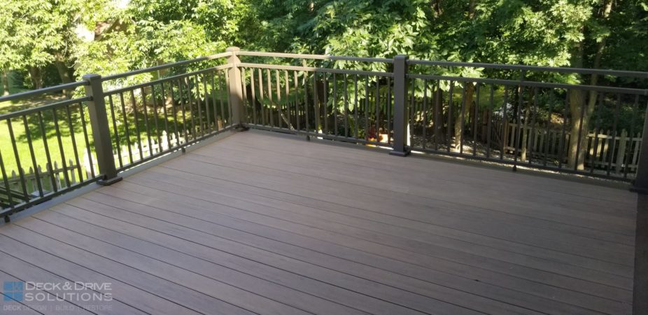 New composite deck with bronze Westbury Railing Rivera double top rail with trees in the back