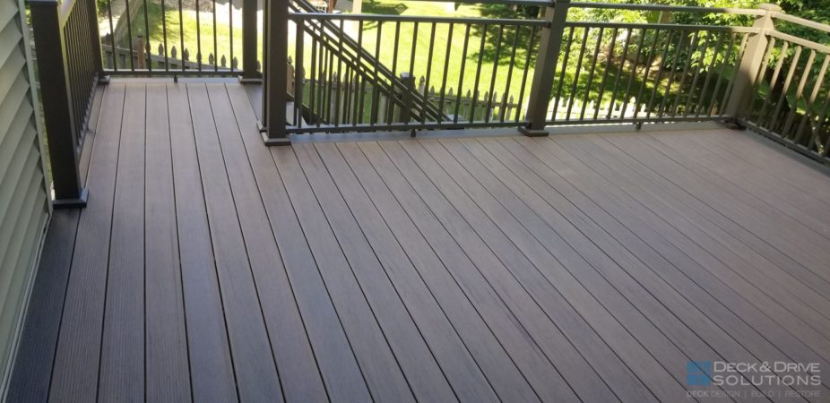 New composite deck with bronze Westbury Railing Rivera double top rail with trees in the back