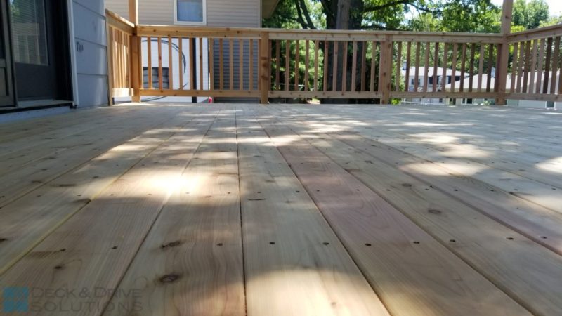 Close up picture of cedar flooring and cedar railing