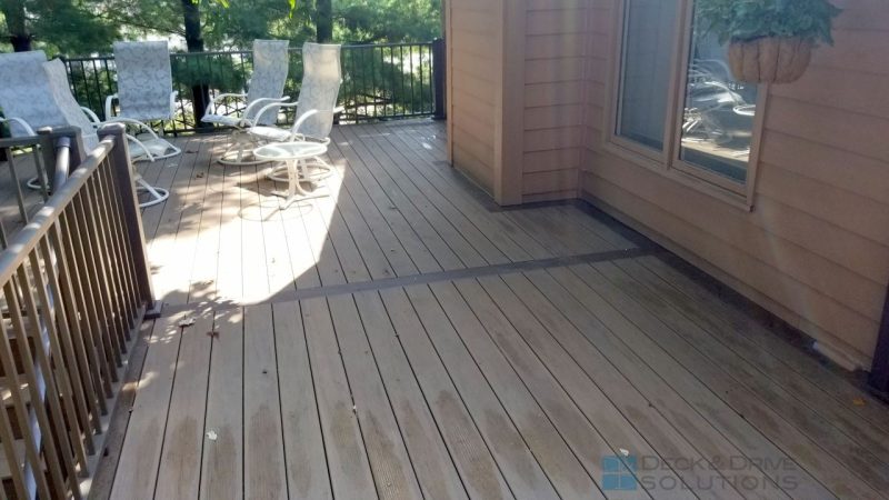 Timbertech Pecan Decking with Middle accent board of mocha, Westbury Railing on a green lot with trees