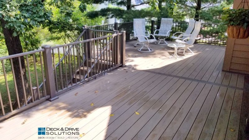 Timbertech Pecan Decking with Middle accent board of mocha, Westbury Railing on a green lot with trees