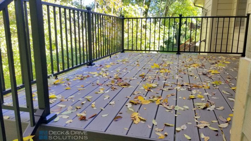 Timbertech Deck in Fall with leaves and green trees in the back