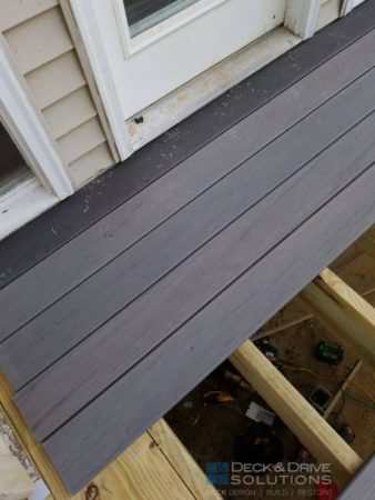 decking getting installed on a wood deck frame