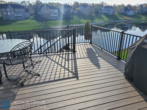 outdoor furniture on composite deck near a lake