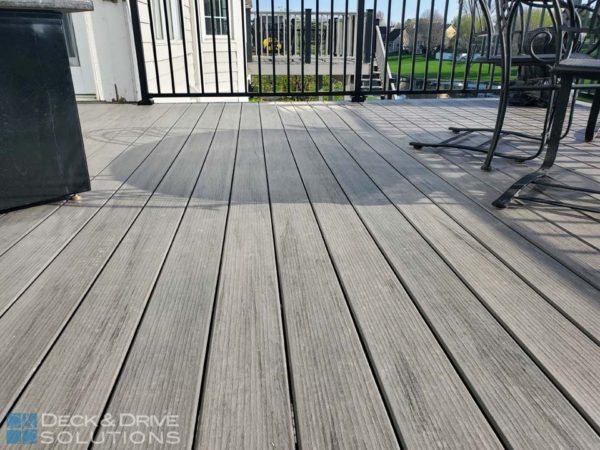 Close up picture of Timbertech PVC Capped Composite Decking in Ashwood with metal railing