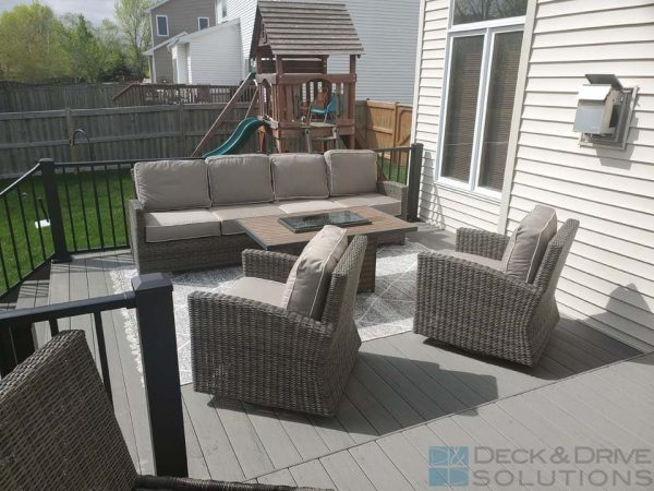 outdoor couch and chairs around firepit on composite deck