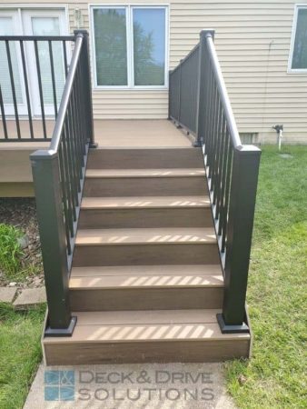Timbertech deck stairs with Mocha as the risers, pecan as the tread, westbury railing with 4" posts