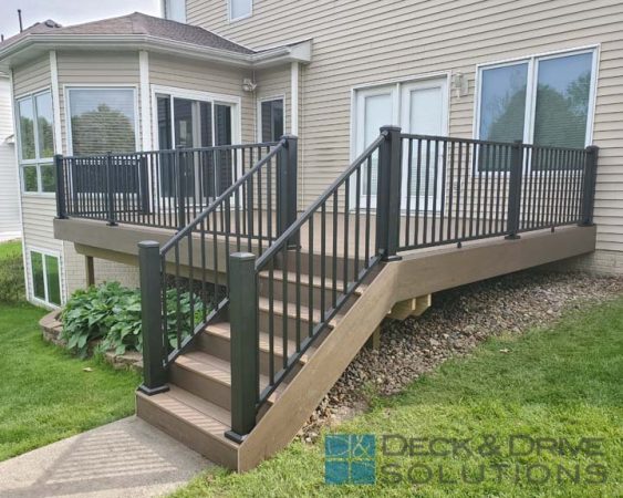 Timbertech deck stairs with Mocha as the risers, pecan as the tread, westbury railing with 4" posts on corner of stairs