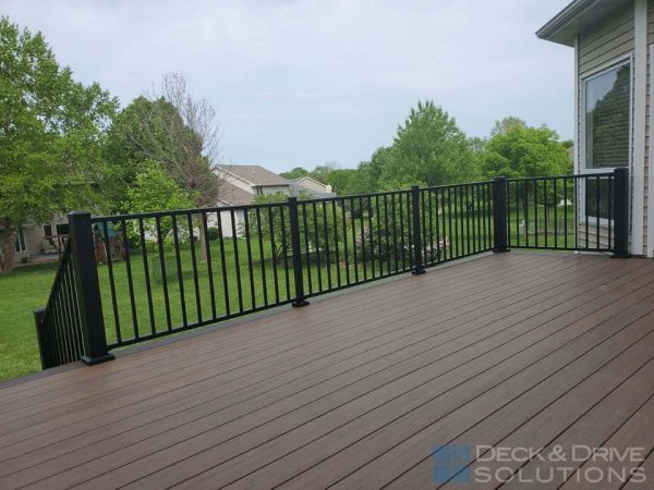 Backyard deck with Pecan decking and black metal railing