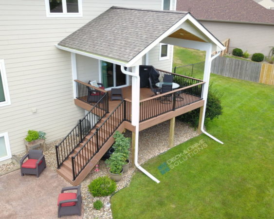 New Covered Deck with Trex Decking and stamped concrete patio at rear of house