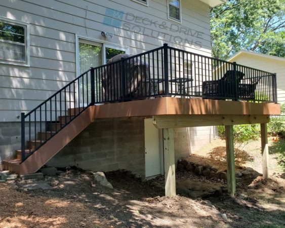 outside deck corner with deck stairs on a gray house
