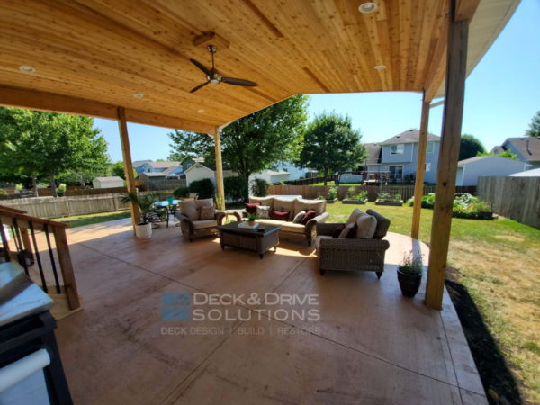 outdoor patio living room under cedar ceiling and colored smoothed concrete