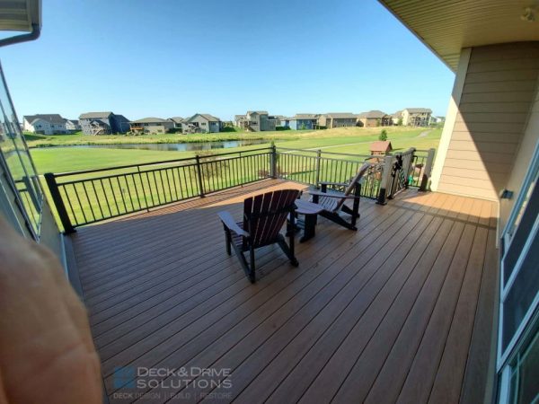deck chairs sitting on new composite deck with rivera railing looking over at a golf course