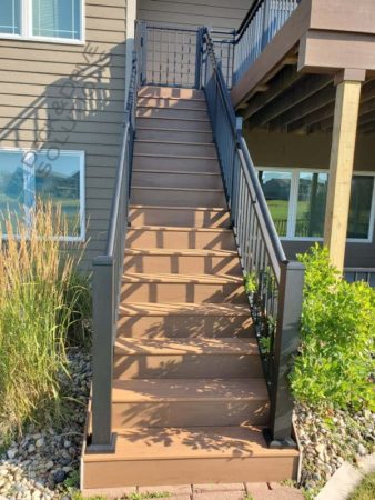 Deck Stairs with tall grass around it