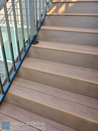 composite deck stairs with black metal railing