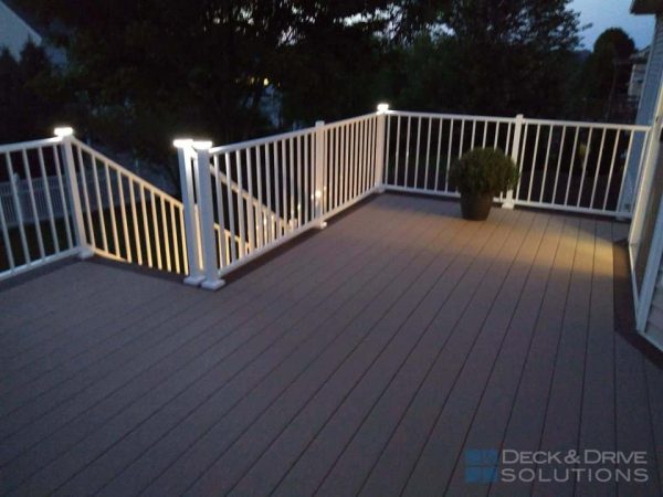 Timbertech deck with white westbury railing white with lights in the evening