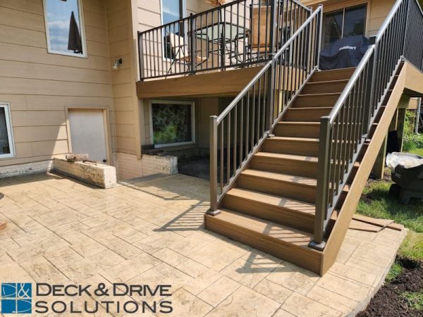 New Deck Stairs landing on stamped concrete