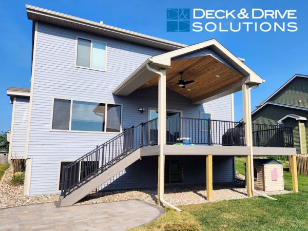 New covered deck with roof and composite decking.  stairs on a new paver patio