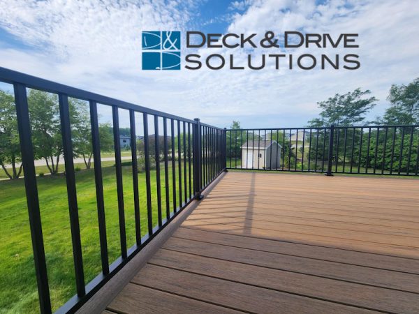 Timbertech antique leather and dark roast decking with black metal railing in backyard