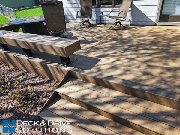 Extra wide deck stairs on a new composite deck with a built in deck bench